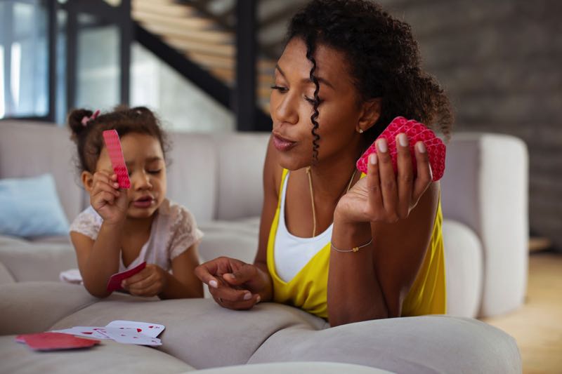 Mother and daughter playing a card game