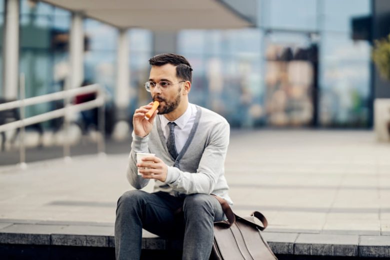 Man drinking coffee and vaping in the morning