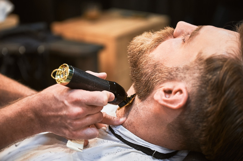 Barber cutting beard