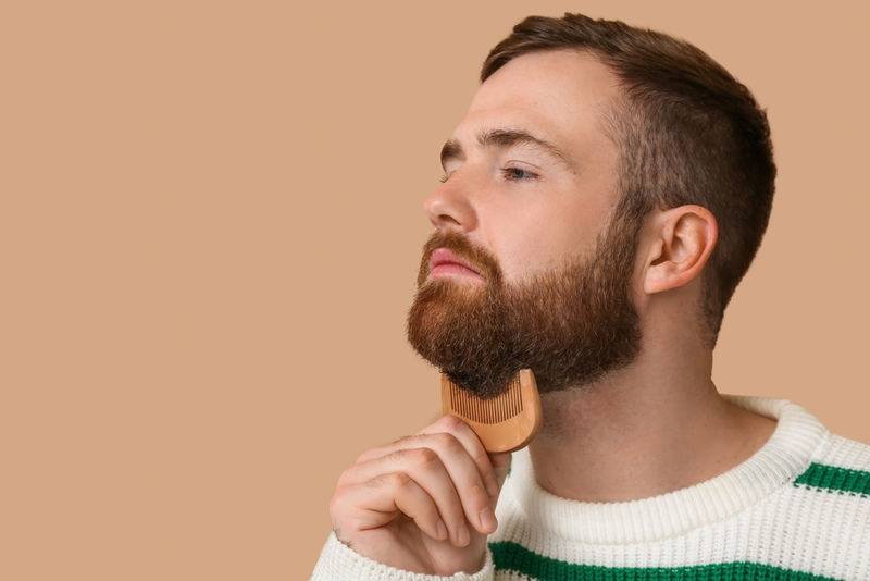 Man brushing beard