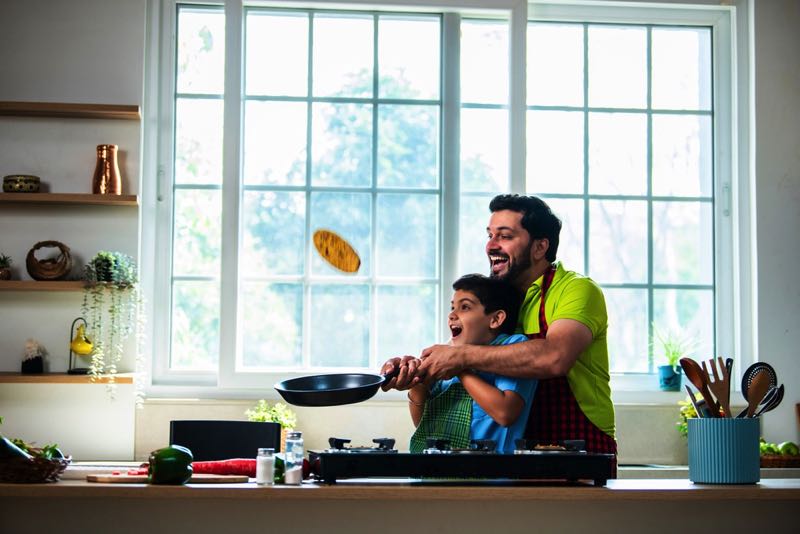 Father and son making pancakes