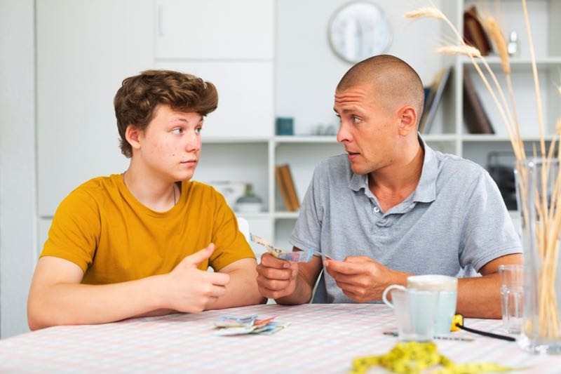 Father and son discussing money