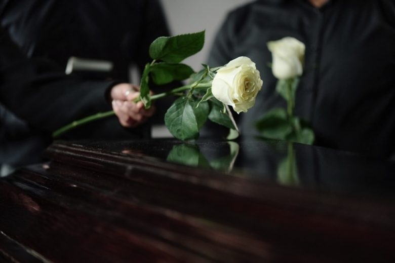 Funeral casket with white rose
