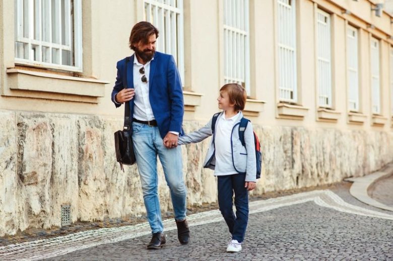Dad walking kid to school